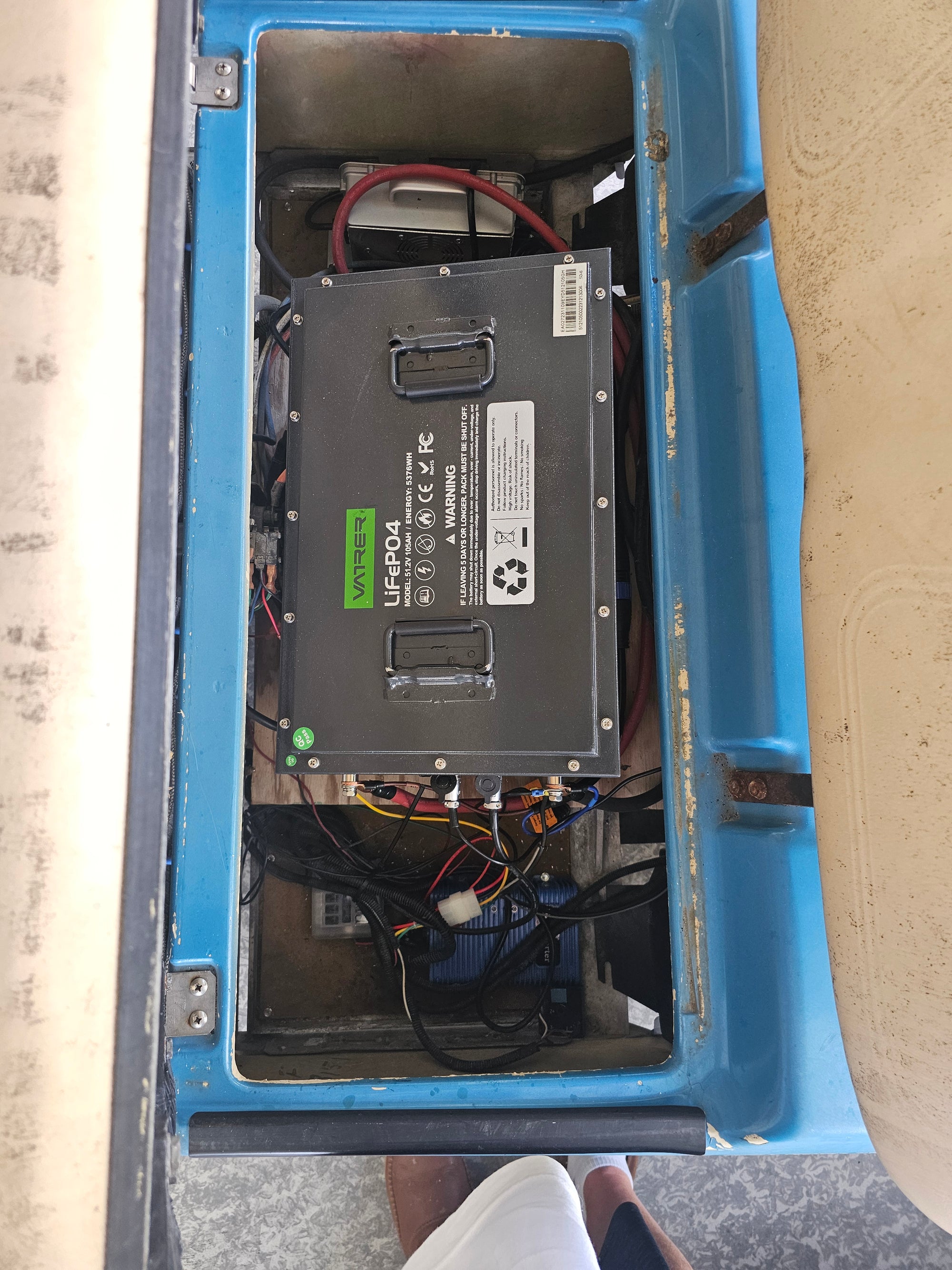 Users install the golf cart lithium battery into the Cushman 18