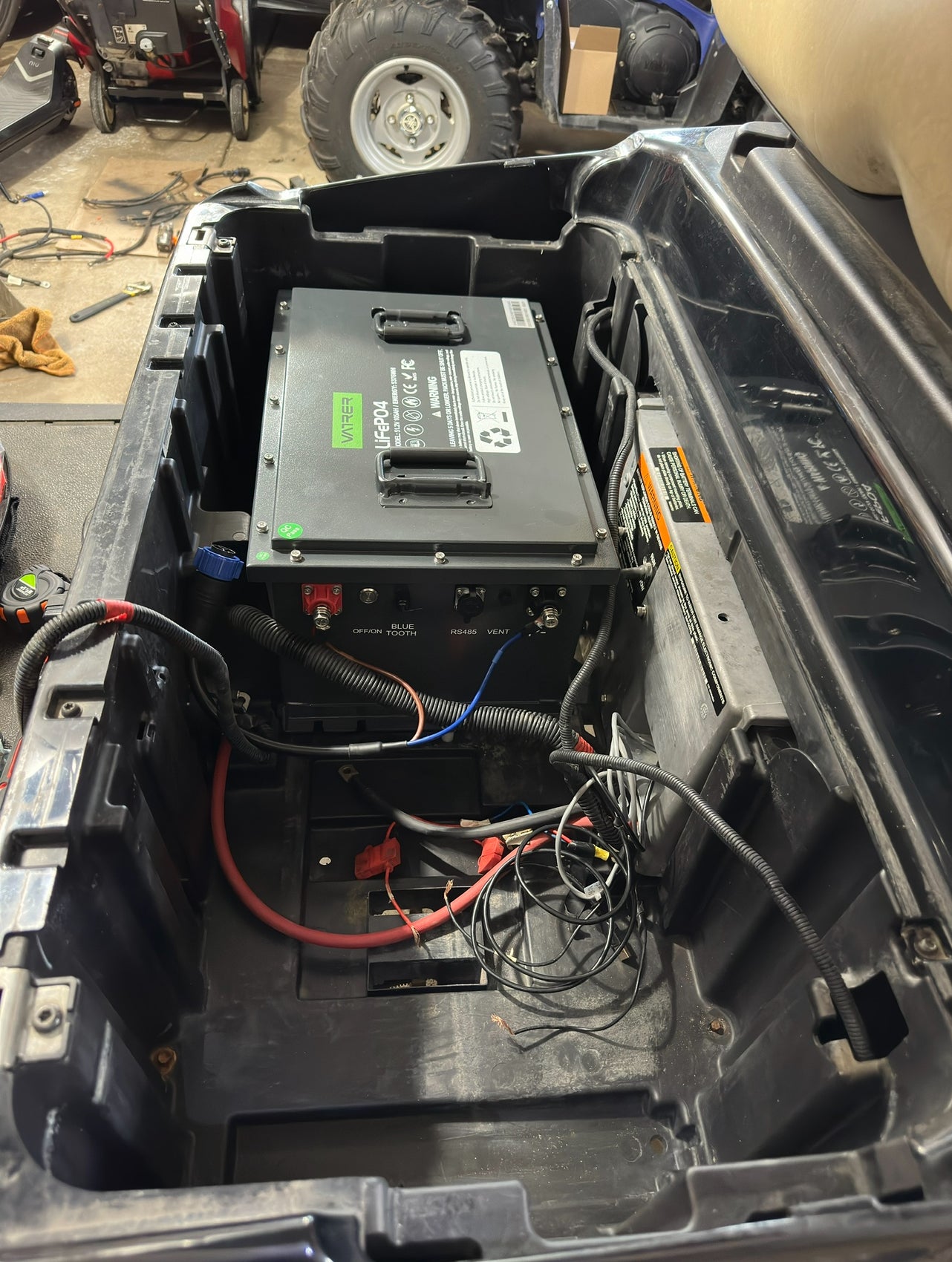 Users install the golf cart lithium battery into the Garia golf cart